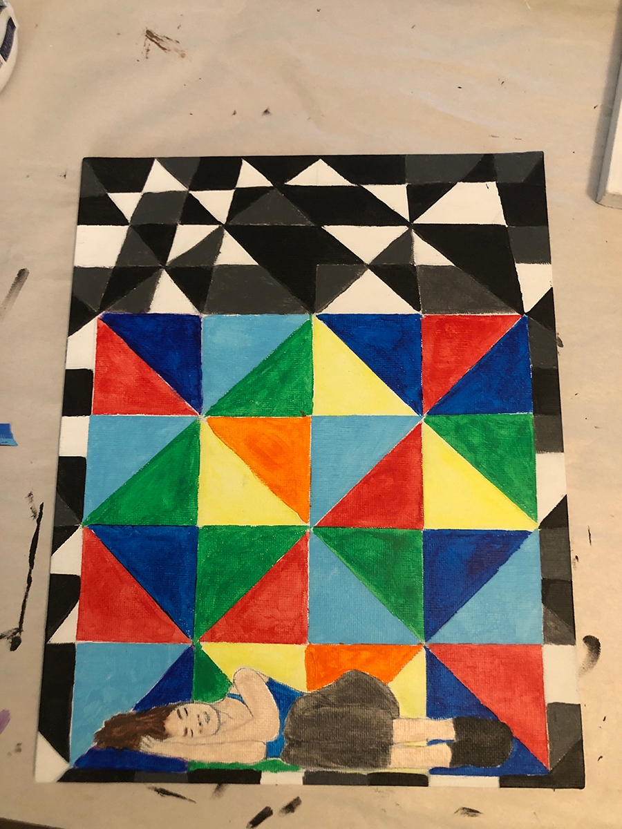 painting with geometrical patterns and a person laying at the bottom